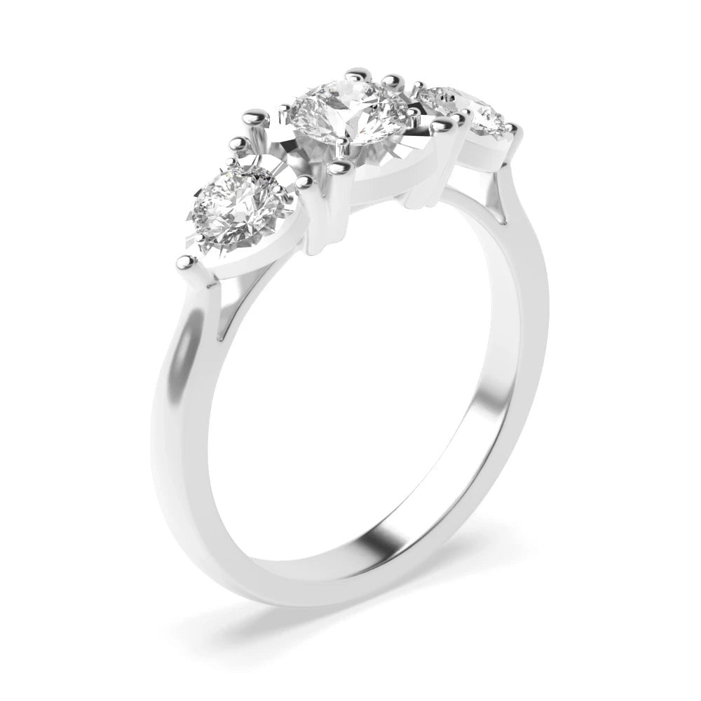 Dante 4 Prong Round 0.10ct Lab Grown Diamond And Pear Shape Illusion Three Stone Engagement Ring